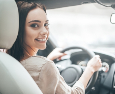 Happy woman getting a new car with Union Plus Auto Buying Service