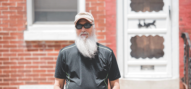 Retired IAM member Paul Sherman stands outside of his home.