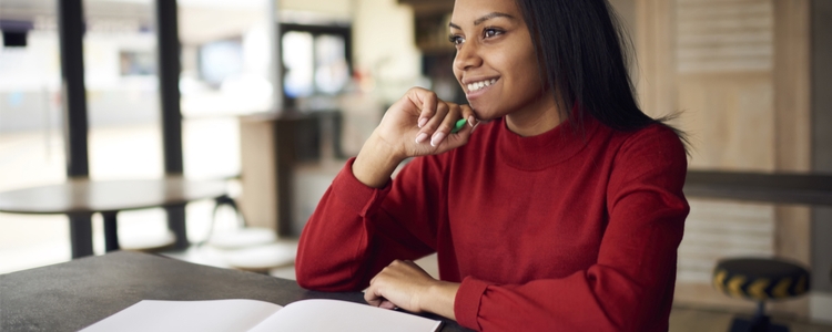 Happy woman devising time-change checklist 