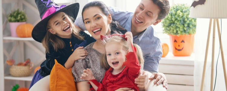 Happy family practicing Halloween fire safety tips