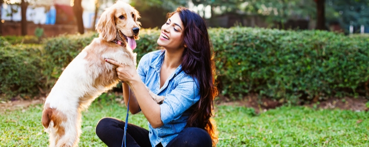 Happy pet owner with dog that has spring allergies and uses Union Plus Pet Health Insurance